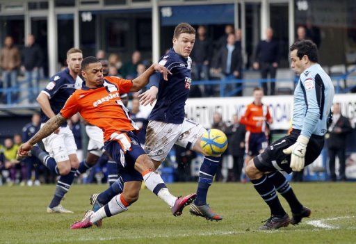 Luton striker Andre Gray (left) has a shot saved by Millwall goalkeeper David Forde on February 16, 2013