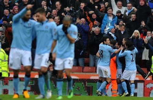 Manchester City's players celebrate scoring a goal against Stoke City, in Stoke-on-Trent, on January 26, 2013