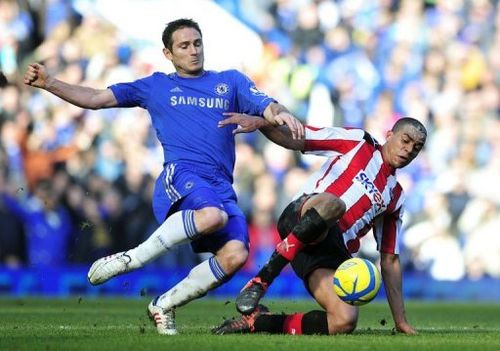 Chelsea's Frank Lampard (L) vies with Brentford's Tom Adeyemi during the match in London on February 17, 2013