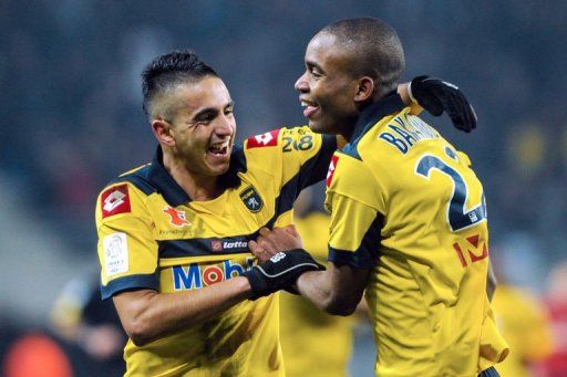 Sochaux&#039; Cedric Bakambu (R) is congratulated by Ryad Boudebouz (L) in Montbeliard on February 17, 2013