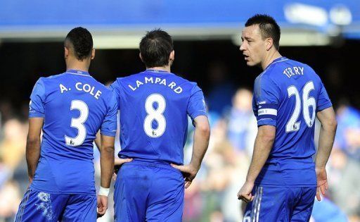 John Terry (R) talks to Chelsea teammates Frank Lampard (C) and Ashley Cole at Stamford Bridge on February 17, 2013