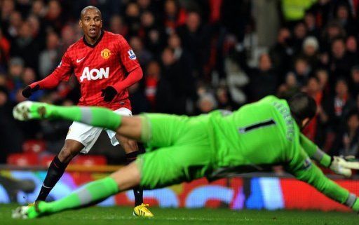 Reading keeper Adam Federici dives to block a shot by Manchester United winger Ashley Young, on February 18, 2013