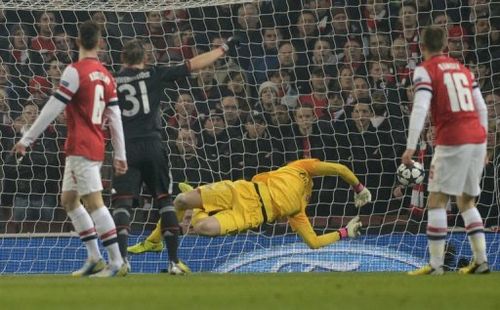 The ball slams into the back of the net past the diving Wojciech Szczesny for Bayern's first goal, on February 19, 2013