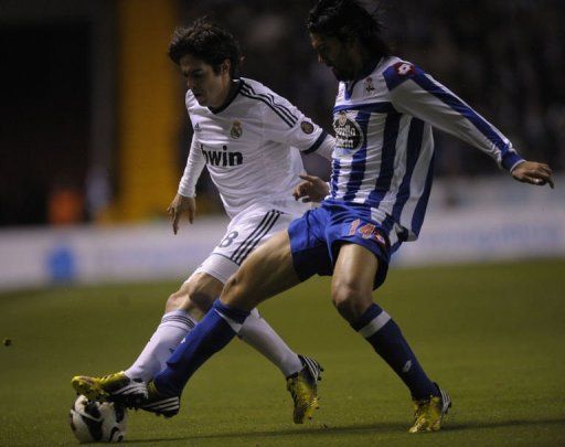 Real Madrid&#039;s midfielder Kaka (L) clashes with Deportivo&#039;s midfielder Abel Aguilar in Coruna on February 23, 2013