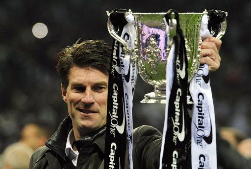 Swansea City&#039;s Michael Laudrup celebrates with the trophy at Wembley Stadium on February 24, 2013