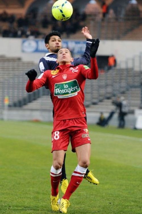 Bordeaux's Benoit Tremoulinas and Brest's Florian Raspentino go head to head on February 24, 2013 in Bordeaux