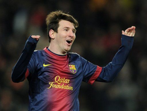 Lionel Messi celebrates after scoring against Sevilla at Camp Nou in Barcelona on February 23