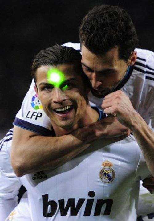 Real Madrid's Cristiano Ronaldo is lit with a green laser at the Camp Nou stadium in Barcelona on February 26, 2013