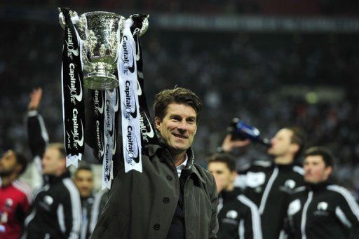 Michael Laudrup celebrates with the trophy after the League Cup final at Wembley on February 24, 2013