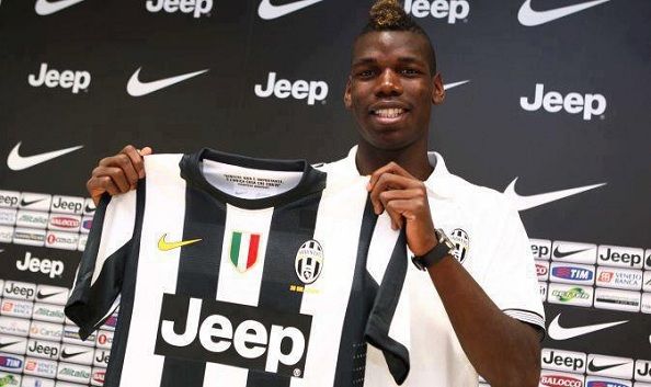 Paul Pogba poses with his new club&#039;s shirt after being transferred from Manchester United to Juventus.