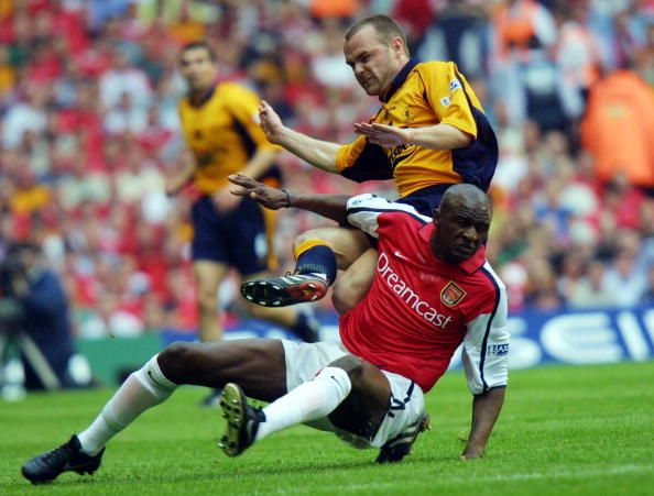 Arsenal&#039;s Patrick Vieira (bottom) is tackled by Li
