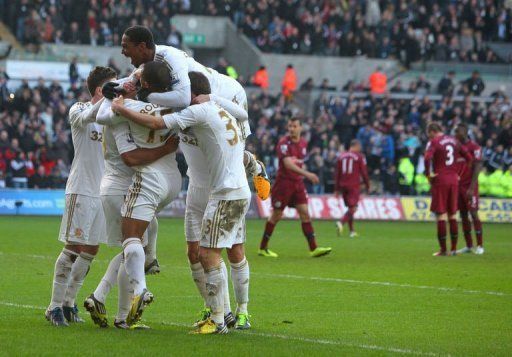 Swansea City&#039;s players celebrate Luke Moore&#039;s goal at Liberty Stadium in Swansea, south Wales, on March 2, 2013