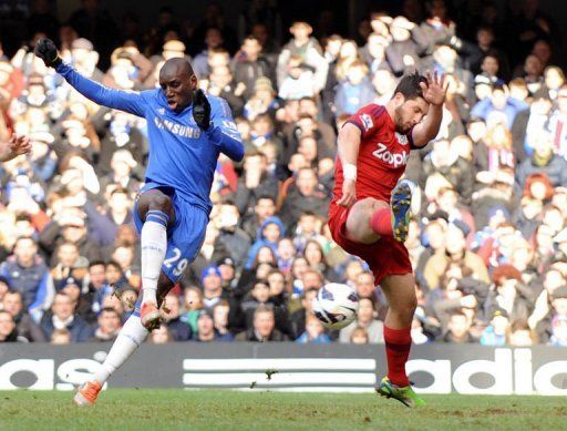 Chelsea&#039;s striker Demba Ba (L) shoots to score past West Bromwich Albion&#039;s striker Shane Long, March 2, 2013