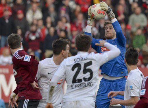 Freiburg&#039;s goalkeeper Oliver Baumann (2nd R) saves the ball in Nuremberg, southern Germany on March 2, 2013