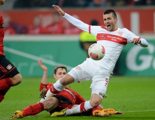 Leverkusen&#039;s Daniel Schwaab and Stuttgart&#039;s Vedad Ibisevic (R) fight for the ball on March 2, 2013