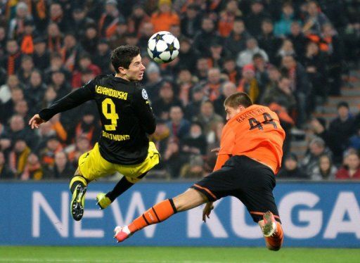 Shakhtar&#039;s Yaroslav Rakitskiy fights for the ball with Dortmund&#039;s Robert Lewandowski, in Donetsk, on February 13, 2013