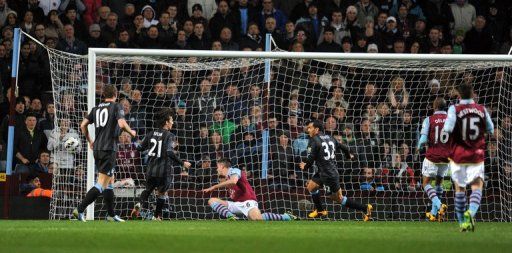 Manchester City striker Carlos Tevez scores against Aston Villa on March 4, 2013