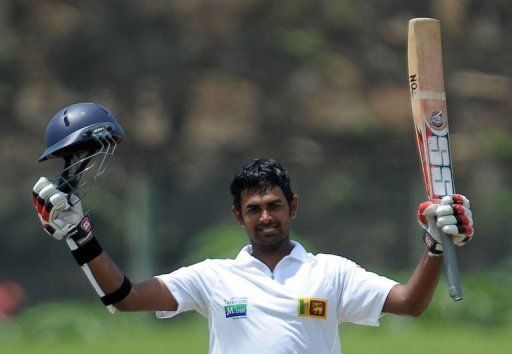Lahiru Thirimanne raises his bat after scoring a century during the opening Test against Bangladesh on March 9, 2013