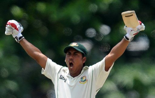 Bangladesh&#039;s Mohammad Ashraful raises his bat in celebration after scoring a century against Sri Lanka on March 10, 2013