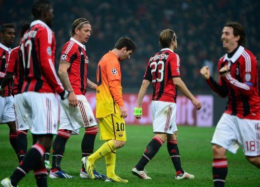 Barcelona forward Lionel Messi (C) cuts a dejected figure in the 2-0 defeat at AC Milan on February 20, 2013