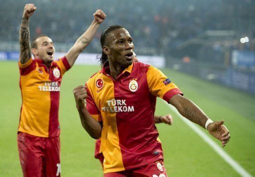 Galatasaray&#039;s Didier Drogba (R) and Wesley Sneijder celebrate beating Schalke on March 12, 2013