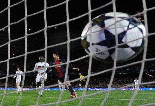 Barcelona's Lionel Messi celebrates scoring against AC Milan at Camp Nou in Barcelona on March 12, 2013