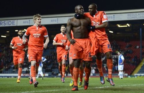 Millwall's Danny Shittu (2nd R) celebrates scoring the opening goal in Blackburn on March 13, 2013