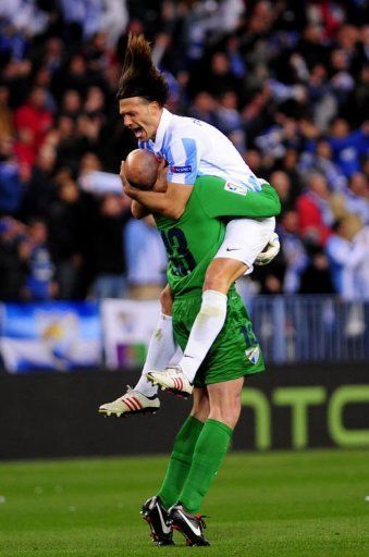 Malaga&#039;s Martin Demichelis (R) and goalkeeper Willy Caballero (L) celebrate in Malaga on March 13, 2013