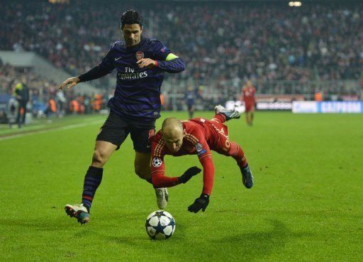Bayern Munich winger Arjen Robben takes a tumble under pressure from Mikel Arteta on March 13, 2013