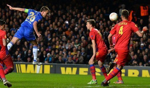 Chelsea&#039;s John Terry (L) heads the ball into the net against Steaua Bucharest at Stamford Bridge on March 14, 2013
