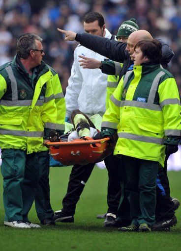 Massadio Haidara is stretchered off the pitch in Wigan on March 17, 2013