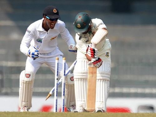 Bangladesh's Mohammad Ashraful (right) is dismissed by Sri Lanka's Rangana Herath (unseen) in Colombo, on March 18, 2013