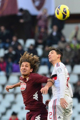 AC Milan defender Mattia De Sciglio (R) goes up for the ball with Torino midfielder Alessio Cerci on December 9, 2012
