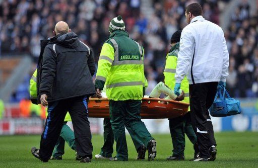 Newcastle United&#039;s Massadio Haidara is stretchered off the pitch in Wigan, on March 17, 2013
