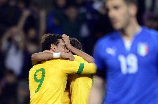 Brazilian midfielder Fred (L) celebrates after scoring during the FIFA World Cup exhibition match on March 21, 2013