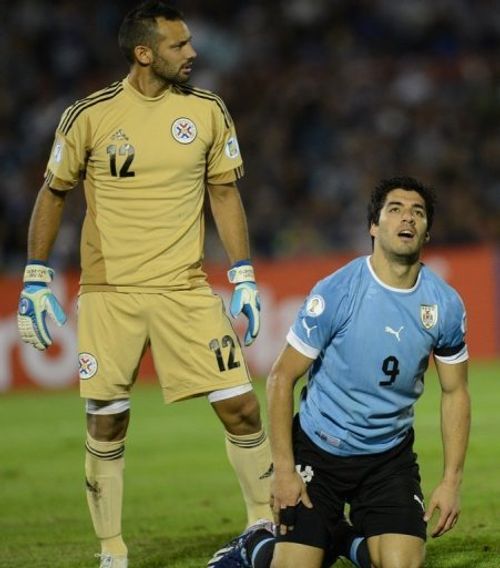 Uruguay's Luis Suarez (R), seen next to Paraguay's goalkeeper Diego Barreto, in Montevideo, on March 22, 2013