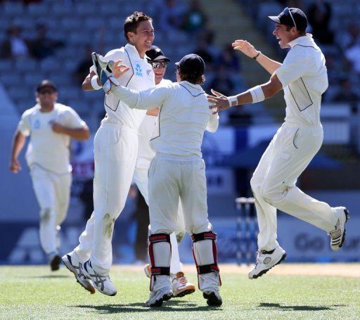Trent Boult (second L) celebrates the wicket of Joe Root at Eden Park on March 26, 2013