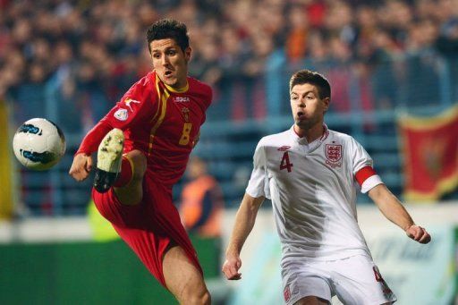 Montenegro forward Stevan Jovetic (L) shields the ball from Steven Gerrard on March 26, 2013