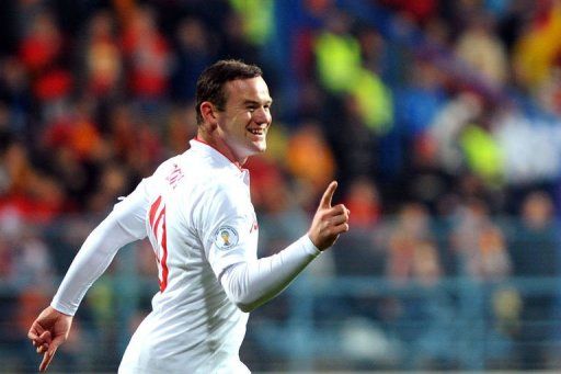 Wayne Rooney celebrates after scoring in Podgorica on March 26, 2013