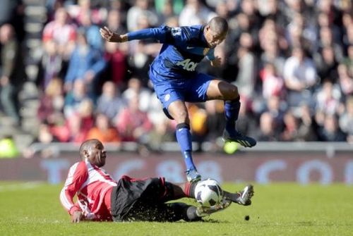 Sunderland's Titus Bramble (left) vies with Manchester United's Ashley Young in Sunderland on March 30, 2013