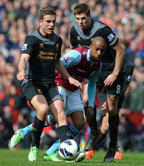 Aston Villa's Fabian Delph (centre) vies with Liverpool's Steven Gerrard (right) and Jordan Henderson (left) on March 31