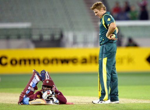 James Faulkner peers down at West Indies batsman Devon Thomas after running him out on February 10, 2013
