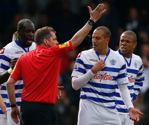 Queens Park Rangers striker Bobby Zamora gets his marching orders from referee Phil Dowd on April 7, 2013