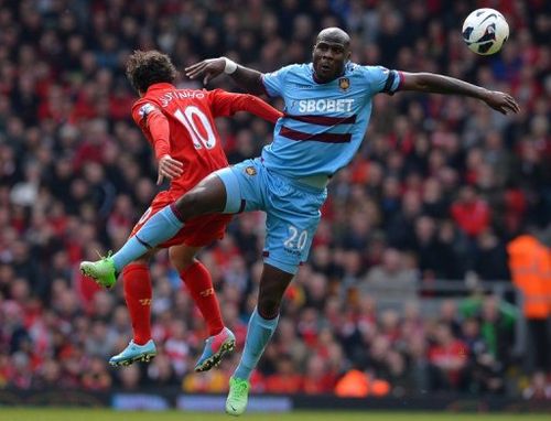 West Ham defender Guy Demel (R) goes up for a header with Liverpool's Philippe Coutinho on April 7, 2013