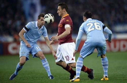 AS Roma's Francesco Totti (C) vies with Lazio's Senad Lilic (L) and Stefan Radu on April 8, 2013 at the Olympic stadium