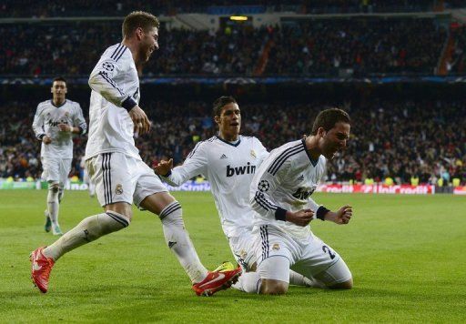 Real Madrid&#039;s Gonzalo Higuain (R) celebrates after scoring during their match against Galatasaray on April 3, 2013