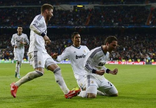 Real Madrid's Gonzalo Higuain (R) celebrates after scoring during their match against Galatasaray on April 3, 2013