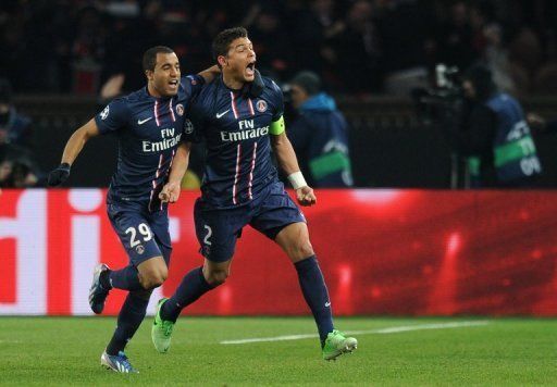 PSG&#039;s Lucas Moura (L) and Thiago Silva are pictured during their match against Barcelona on April 2, 2013