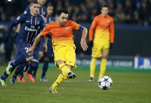 Barcelona&#039;s Xavi Hernandez scores a penalty during their Champions League match against PSG on April 2, 2013