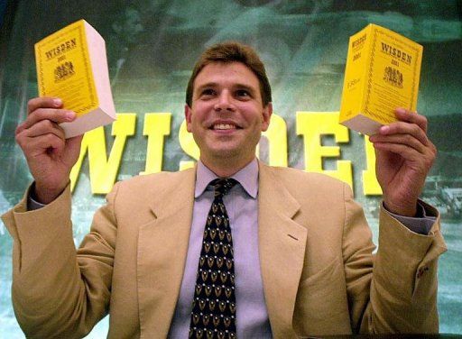 Wisden official Anthony Boucher in Bombay on July 26, 2001 with copies of Wisden&#039;s book on the top 100 cricketers